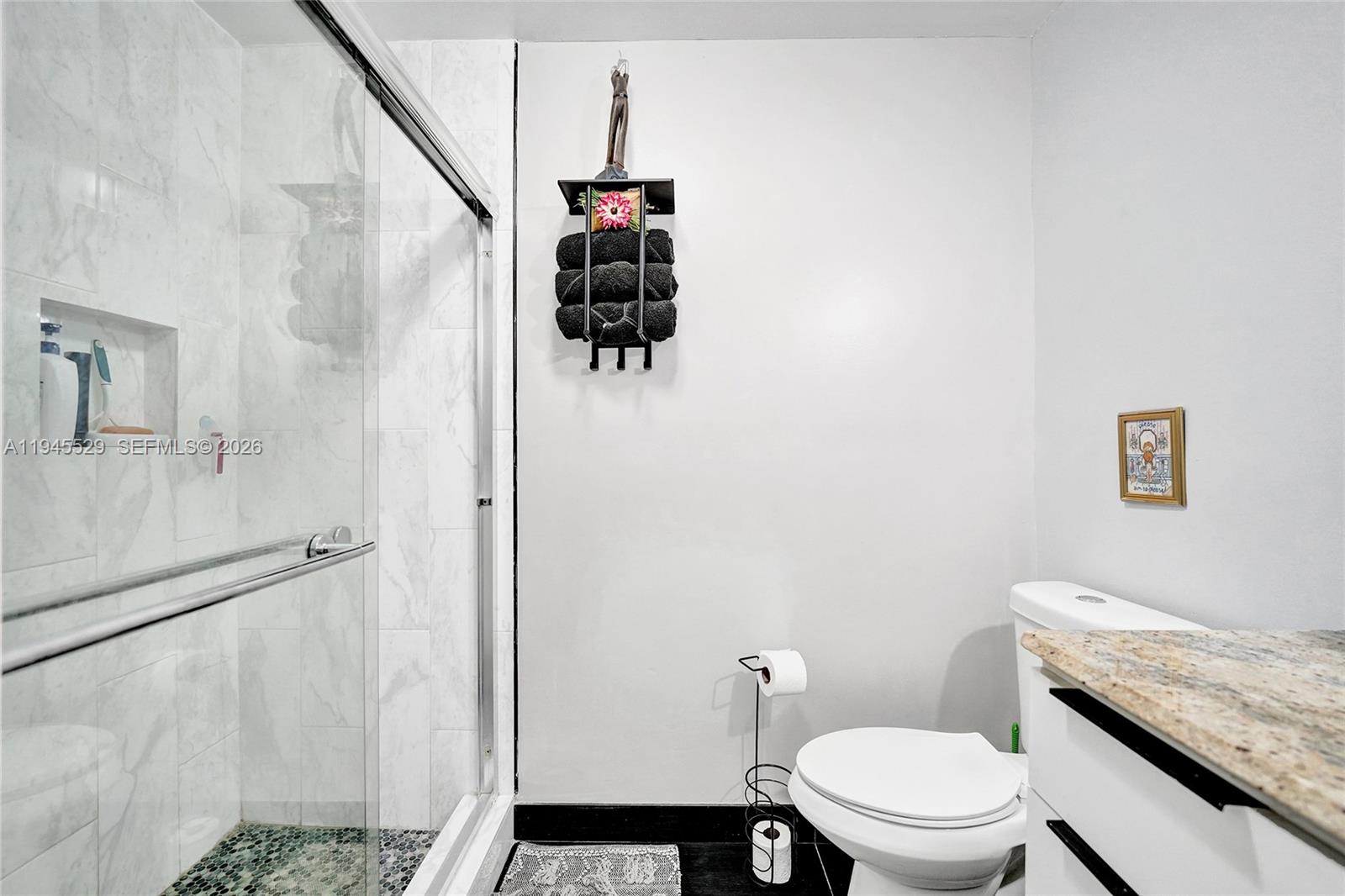 3301 Raleigh Street, Unit 4E Hollywood, FL 33021 - Photo 57 of 80 a bathroom with a granite countertop toilet and a shower