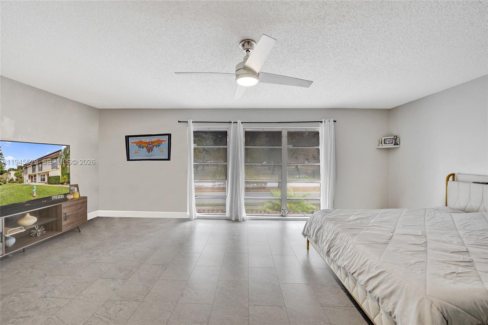 3301 Raleigh Street, Unit 4E Hollywood, FL 33021 - Photo 60 of 80 a bedroom with a bed and a large window