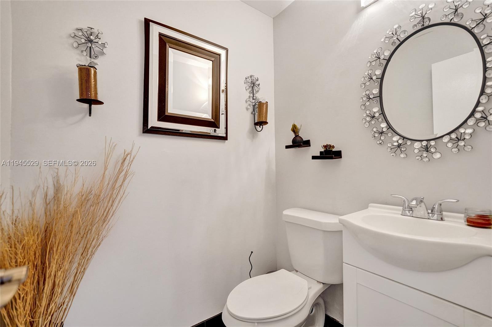 3301 Raleigh Street, Unit 4E Hollywood, FL 33021 - Photo 6 of 80 a bathroom with a toilet sink and mirror