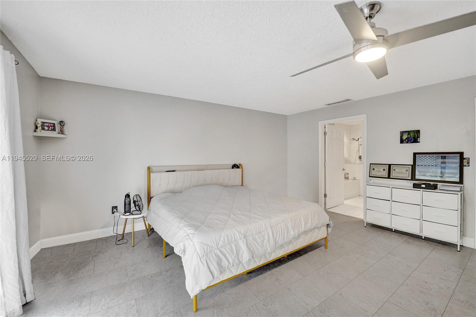 3301 Raleigh Street, Unit 4E Hollywood, FL 33021 - Photo 63 of 80 a bed room with a bed and a chandelier