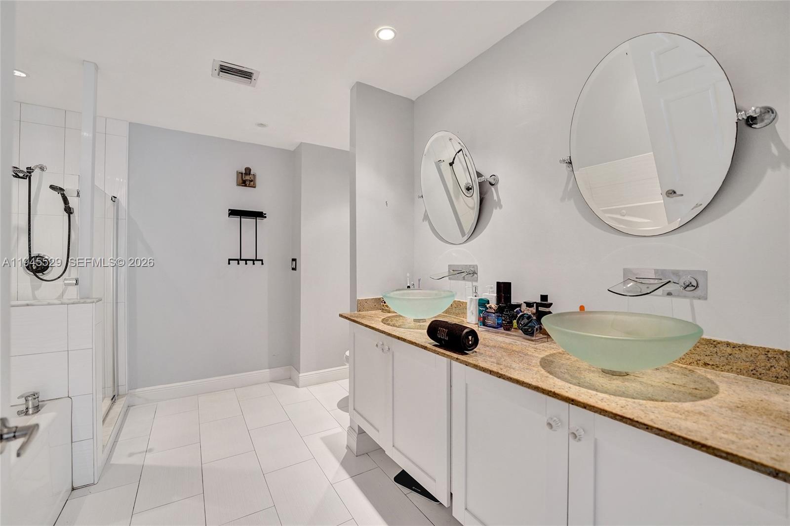 3301 Raleigh Street, Unit 4E Hollywood, FL 33021 - Photo 65 of 80 a bathroom with a granite countertop sink a mirror and shower