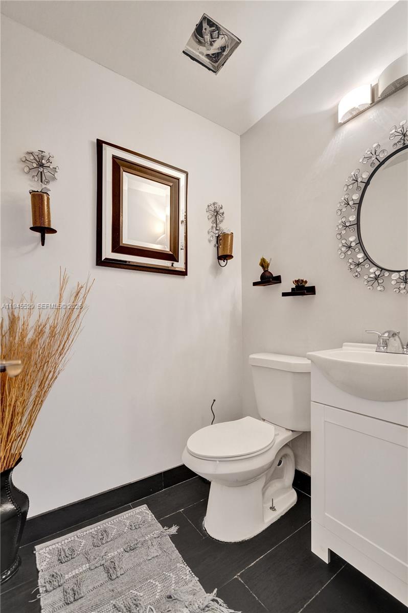 3301 Raleigh Street, Unit 4E Hollywood, FL 33021 - Photo 7 of 80 a bathroom with a toilet sink and mirror