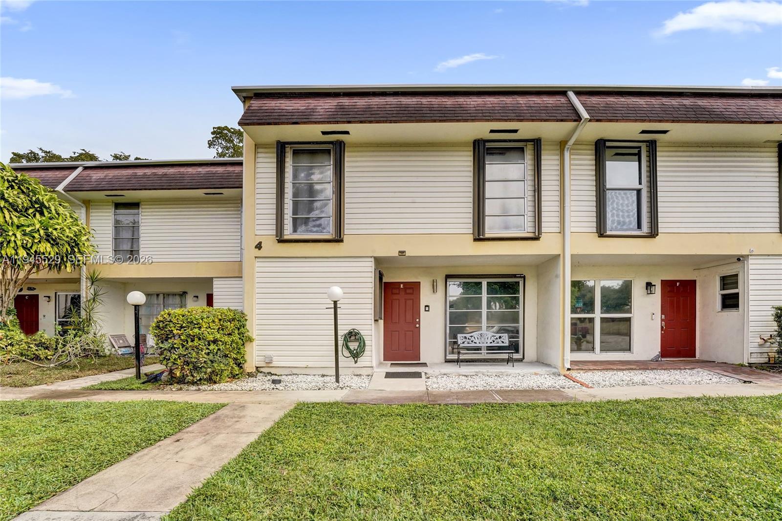 3301 Raleigh Street, Unit 4E Hollywood, FL 33021 - Photo 76 of 80 front view of a house with a yard