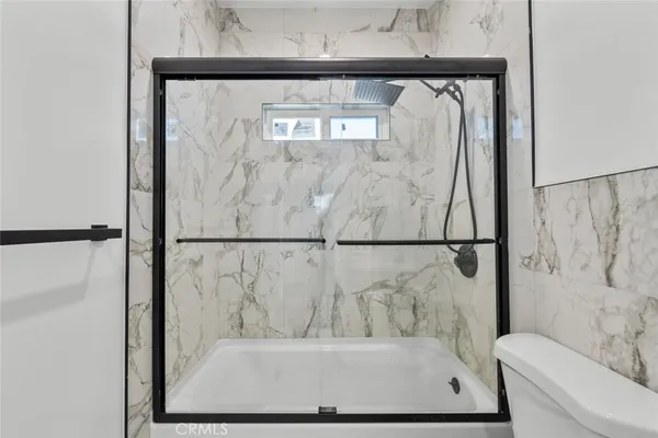 a view of bathroom with a bathtub and shower