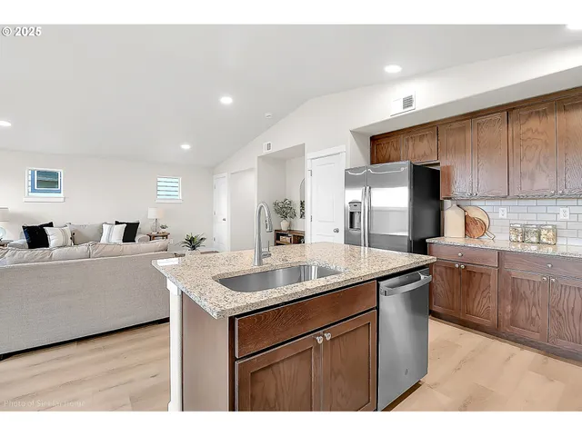 a kitchen that has a sink and a stove in it