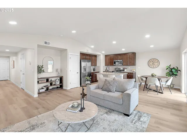 a living room with furniture and kitchen view