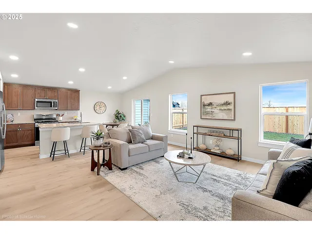 a living room with furniture and kitchen view