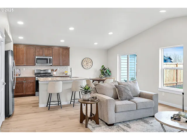 a living room with furniture and kitchen view