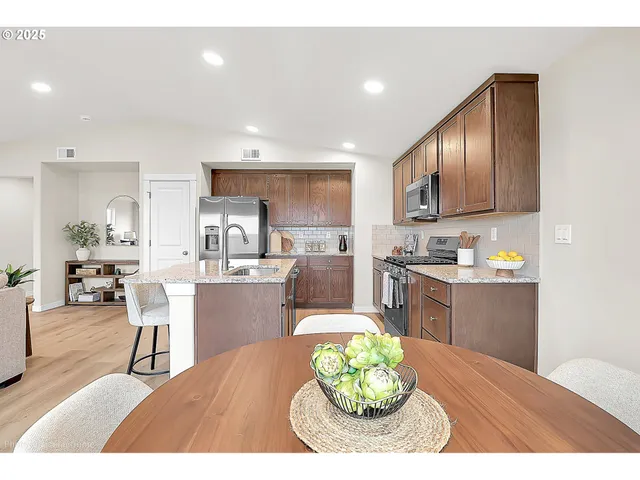 a kitchen with a table and chairs in it