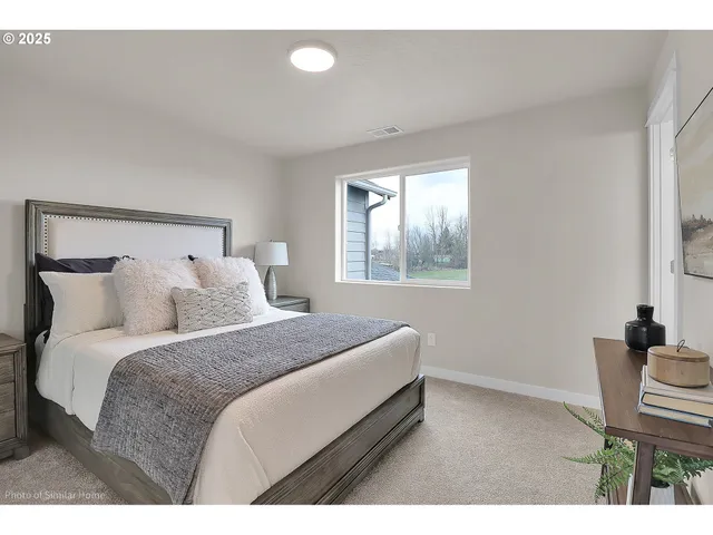 a bedroom with a bed and chair