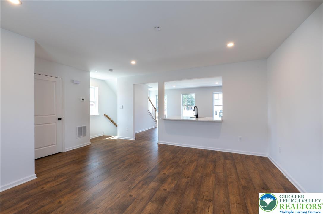 560 Long Street, Unit 4 Emmaus, PA 18049 - Photo 3 of 16 a view of an empty room with wooden floor and a window