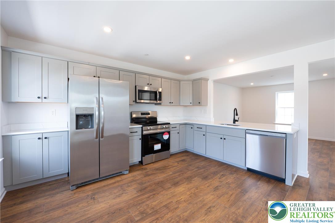 560 Long Street, Unit 4 Emmaus, PA 18049 - Photo 4 of 16 a kitchen with a refrigerator stove top oven and sink