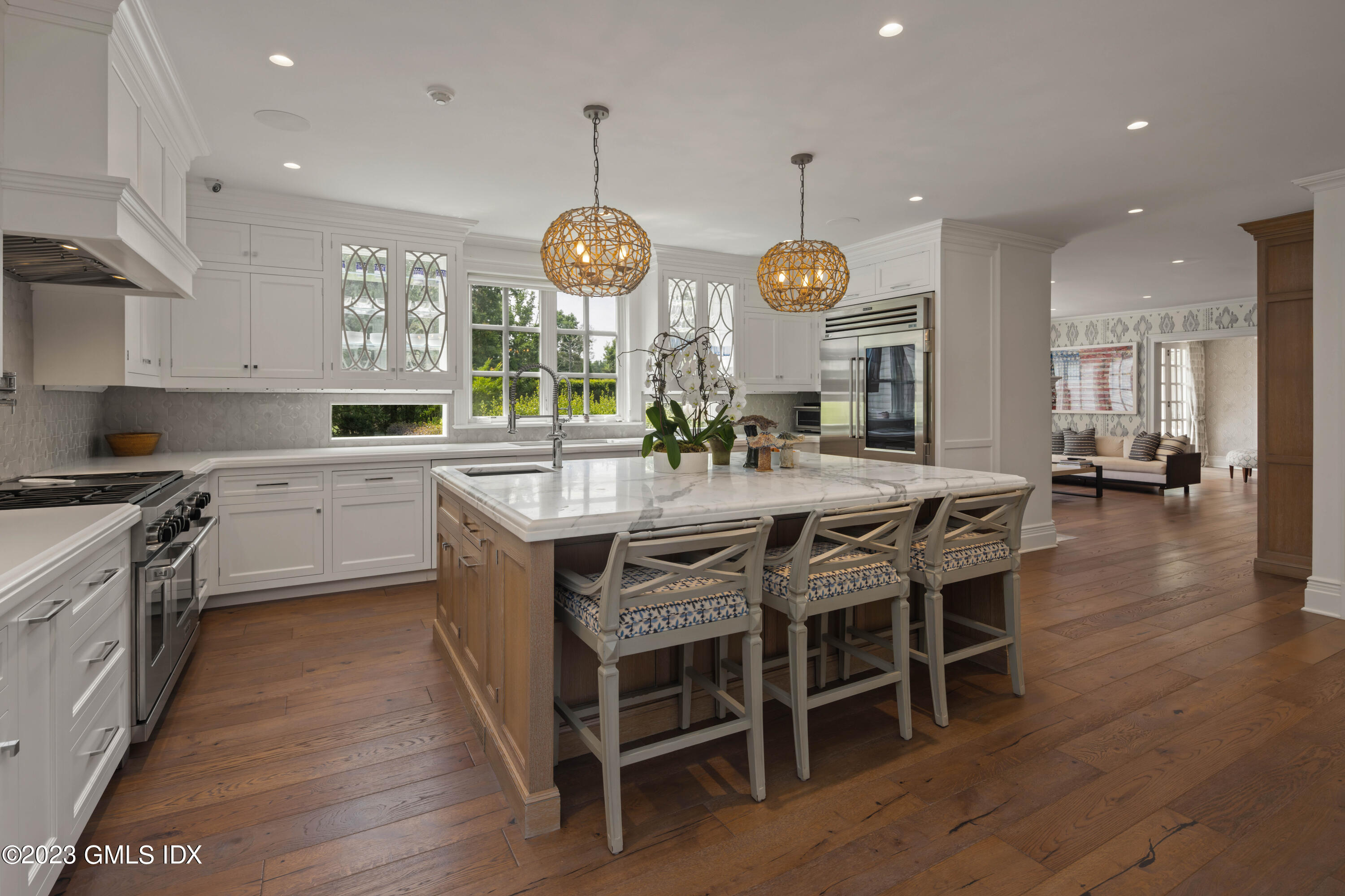 80 Round Hill Road Greenwich, CT 06831 - Photo 17 of 57 a kitchen with stainless steel appliances kitchen island granite countertop a table chairs and a chandelier