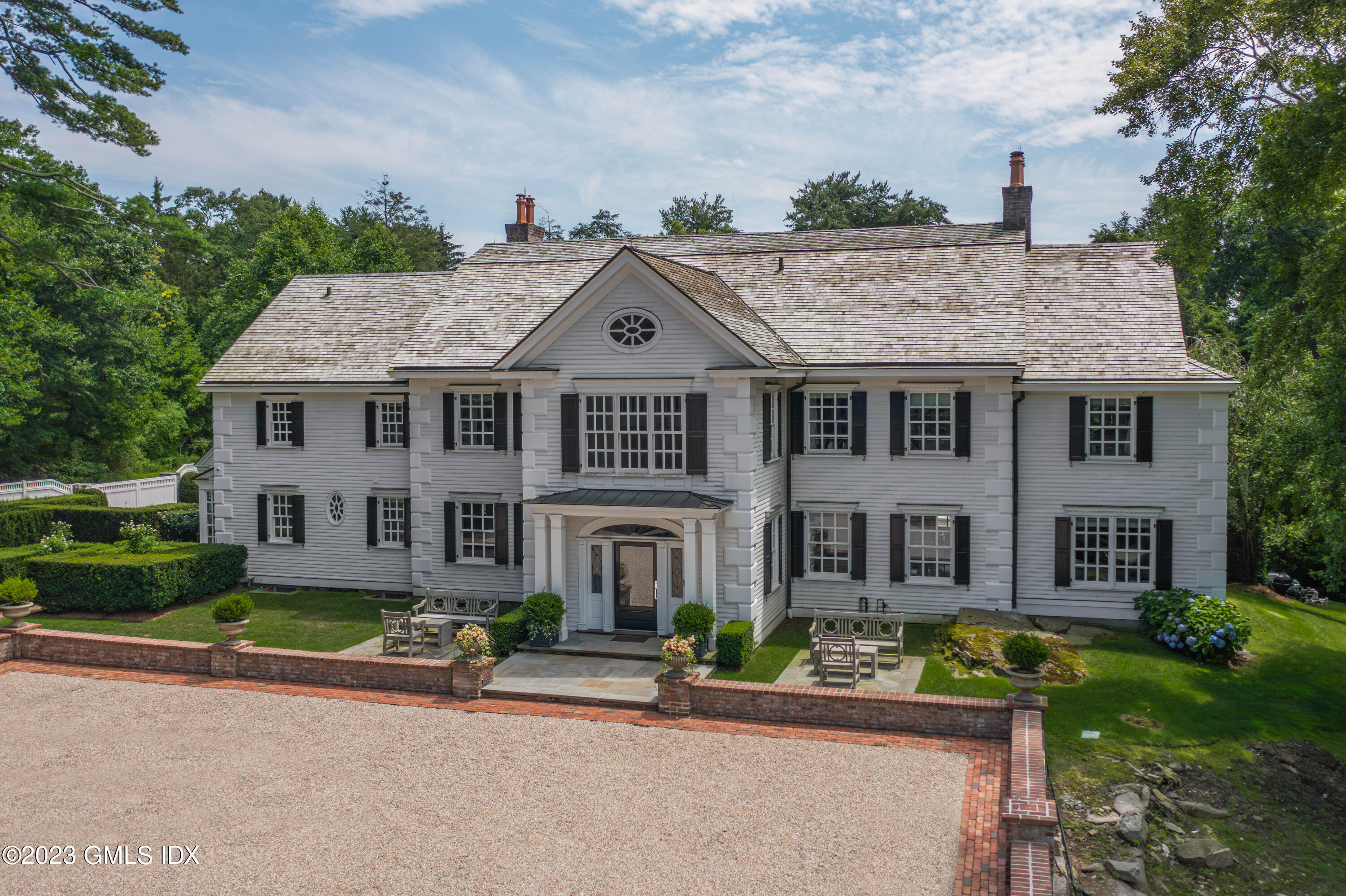 80 Round Hill Road Greenwich, CT 06831 - Photo 2 of 57 a front view of a house with a yard