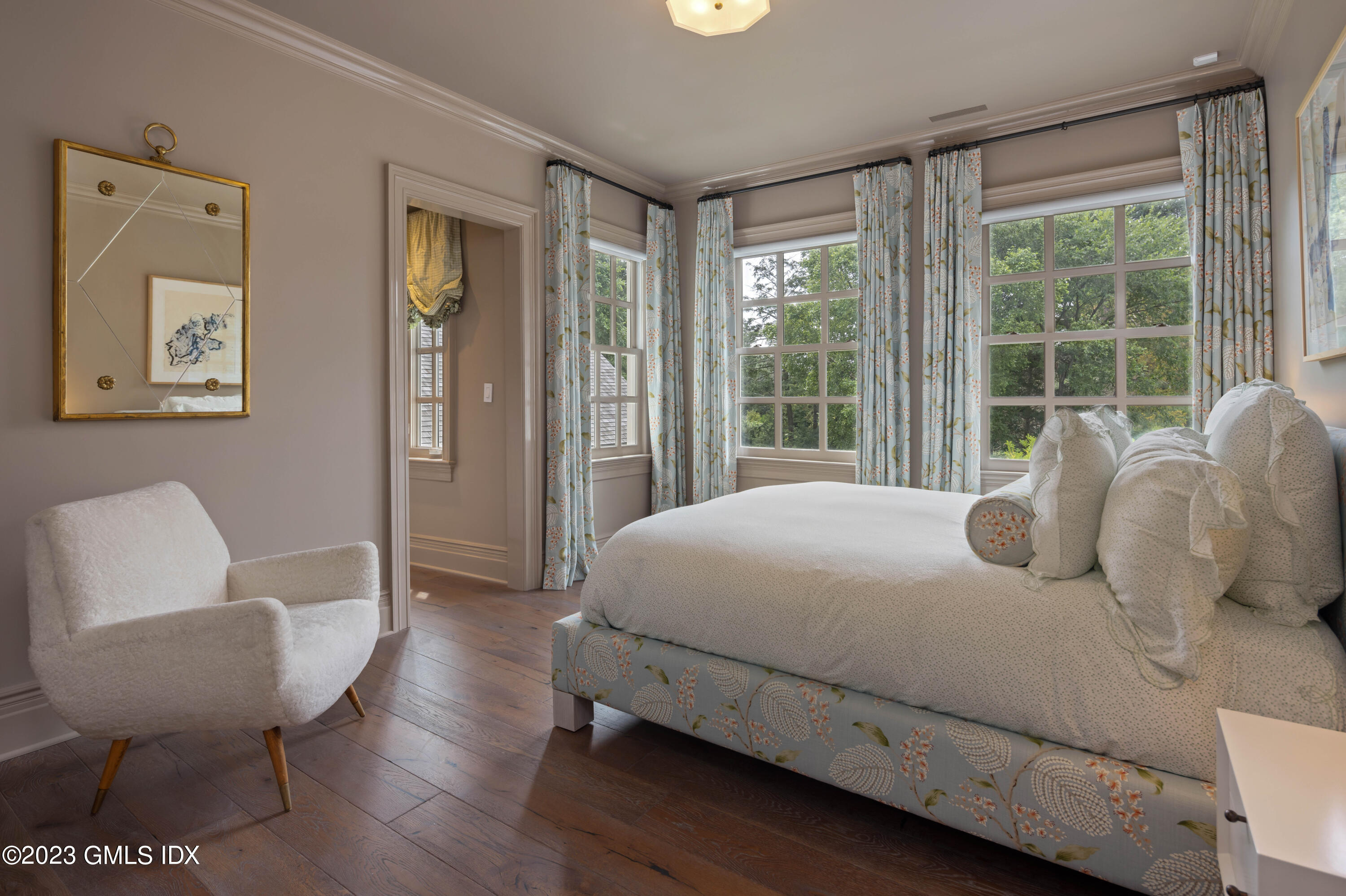 80 Round Hill Road Greenwich, CT 06831 - Photo 34 of 57 a bedroom with a bed and a chair