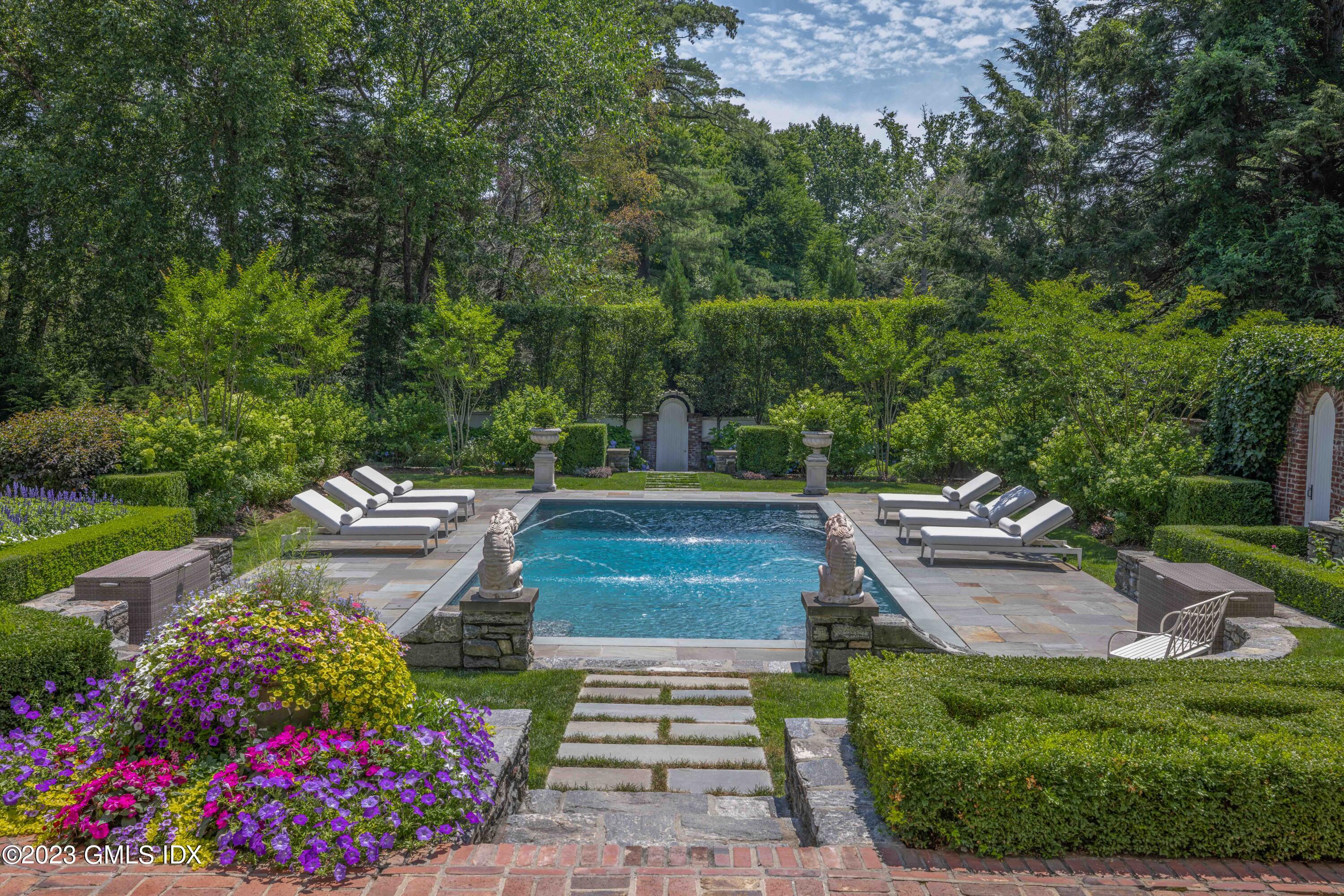 80 Round Hill Road Greenwich, CT 06831 - Photo 41 of 57 a view of a garden with plants and large trees