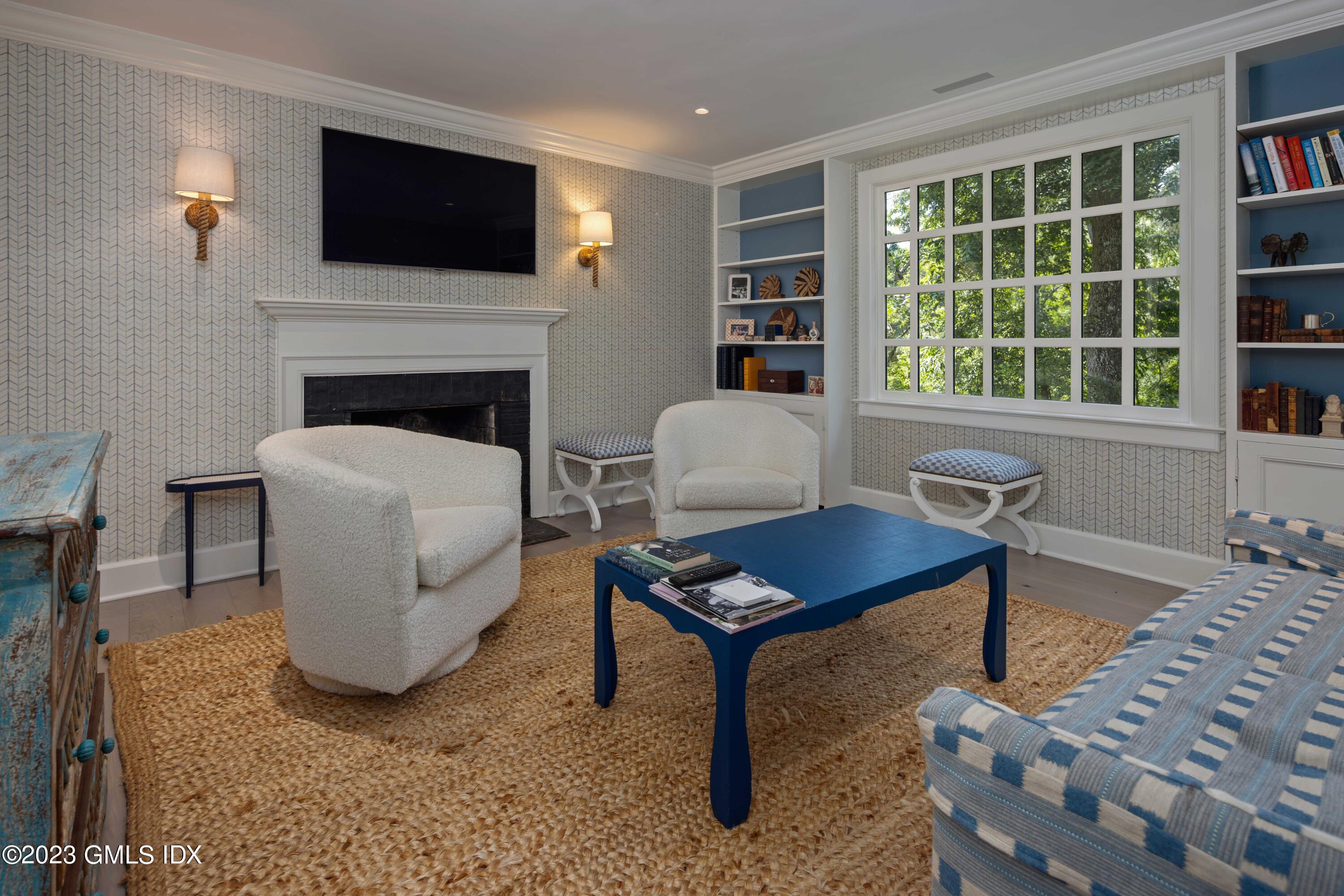 80 Round Hill Road Greenwich, CT 06831 - Photo 43 of 57 a living room with furniture a flat screen tv and a fireplace
