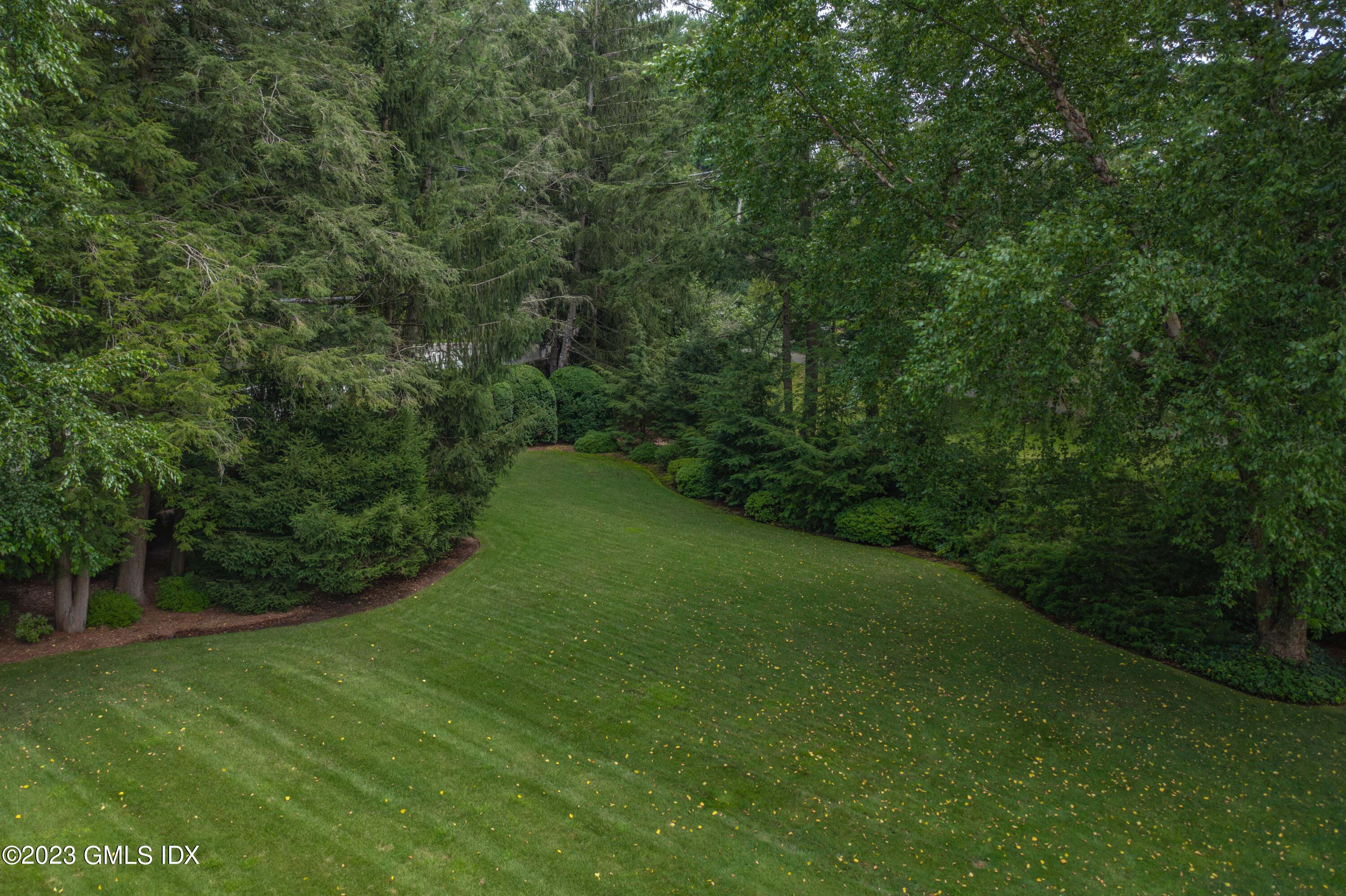 80 Round Hill Road Greenwich, CT 06831 - Photo 47 of 57 a view of a field of grass and trees
