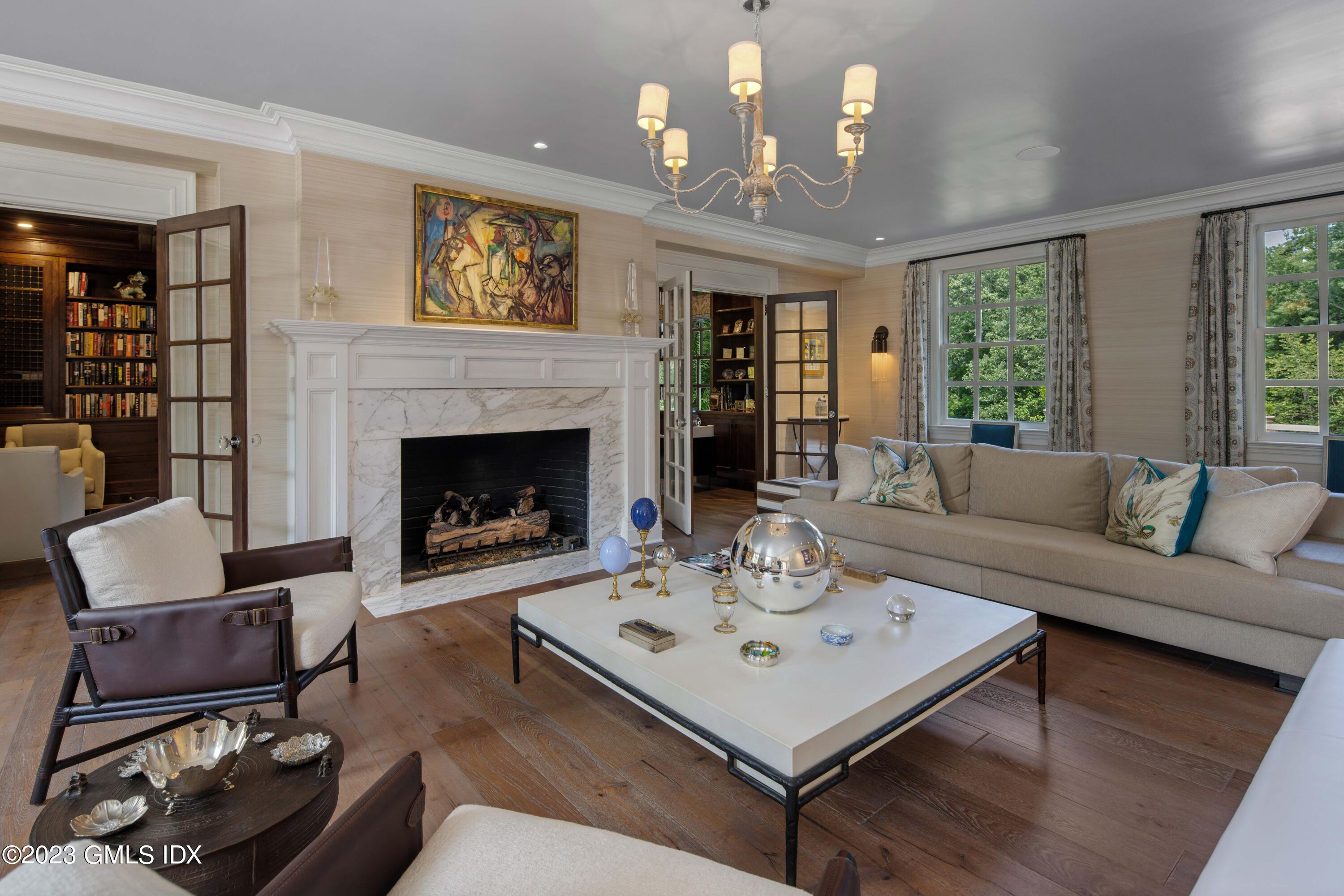 80 Round Hill Road Greenwich, CT 06831 - Photo 6 of 57 a living room with furniture a chandelier and a fireplace