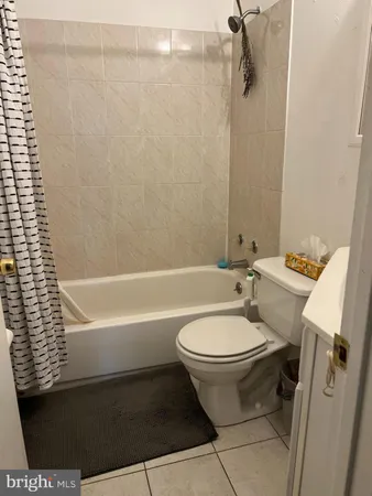a bathroom with a toilet a sink and bathtub