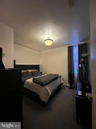 a bedroom with a bed and a ceiling fan