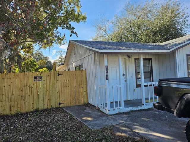 a view of an empty room and chandelier fan