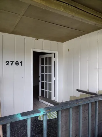a view of a house with entryway and wooden walls
