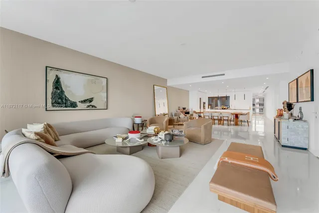 a living room with furniture and a view of kitchen