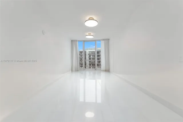 a bedroom with a bed and a lamp on dresser