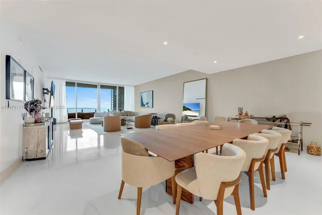 a view of a dining room with furniture and a chandelier
