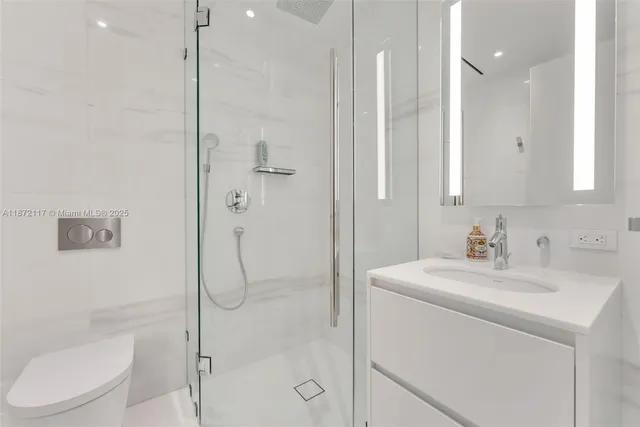 a large bed sitting in a bedroom next to a window