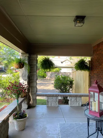 a front view of a house with a garden and porch