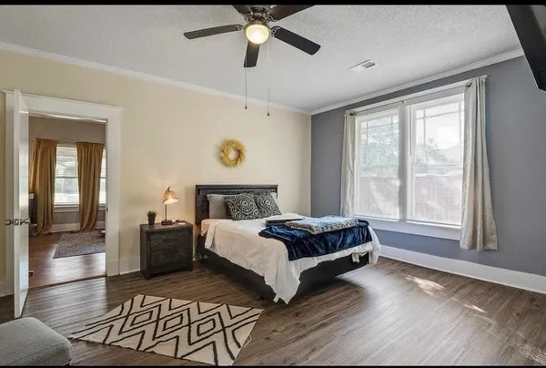 a bedroom with a bed and a potted plant
