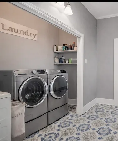a utility room with sink dryer and washer
