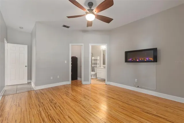 a view of empty room with wooden floor