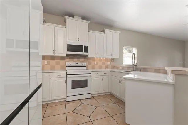 a kitchen with appliances cabinets and a sink