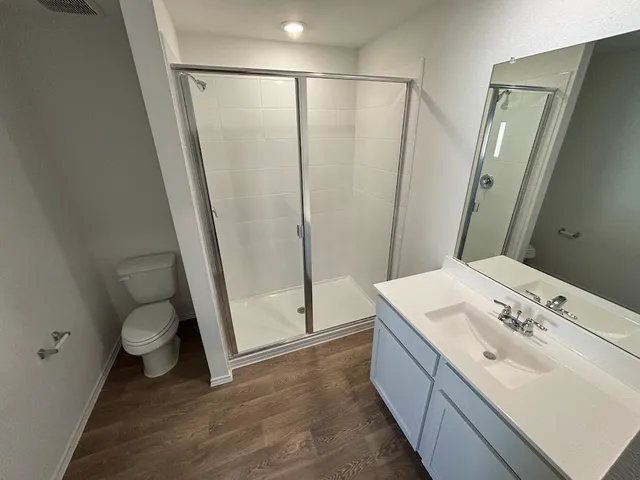 a bathroom with a sink a toilet and a mirror