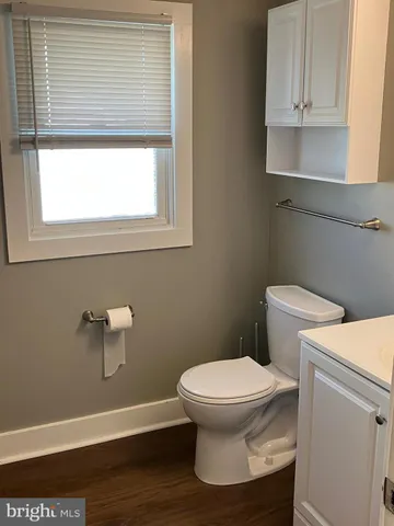 a bathroom with a toilet and a window