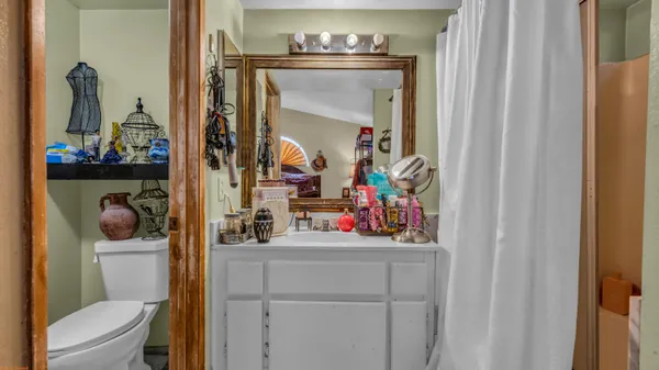 a bathroom with a toilet sink and mirror