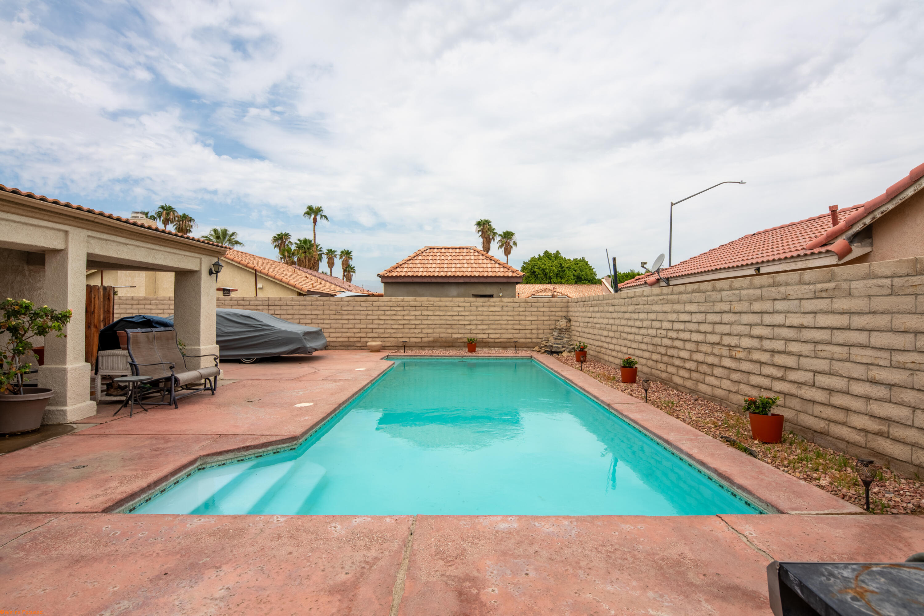 80928 Brown Street Indio, CA 92201 - Photo 29 of 35 a view of a backyard with swimming pool and sitting area