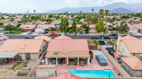 an aerial view of a house with a swimming pool