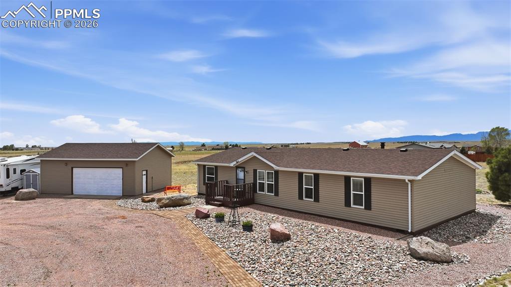 20985 McDaniels Road Calhan, CO 80808 - Photo 3 of 41 a view of a house with a yard