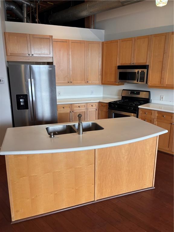 204 Walker Street Southwest, Unit 314 Atlanta, GA 30313 - Photo 12 of 42 a kitchen with stainless steel appliances a refrigerator a sink a stove a microwave and wooden cabinets