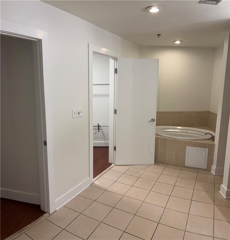 204 Walker Street Southwest, Unit 314 Atlanta, GA 30313 - Photo 26 of 42 a bathroom with a sink a toilet and a shower