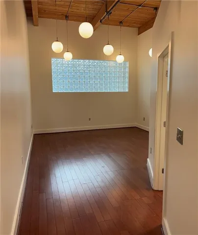 a view of a room with wooden floor and fan