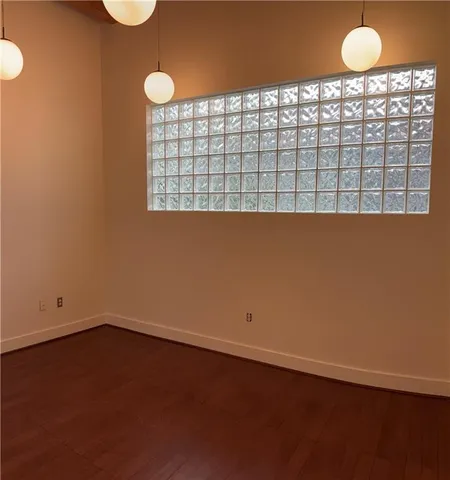a view of a room with wooden floor and window