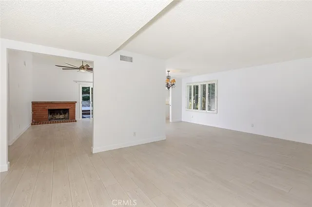 a view of an empty room with a fireplace
