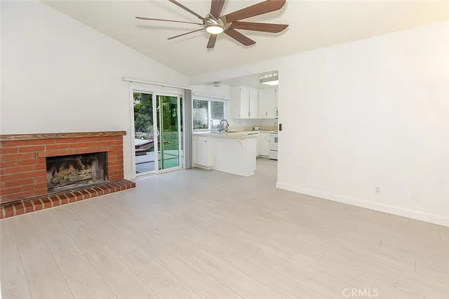 a view of a kitchen with stove and more cabinets