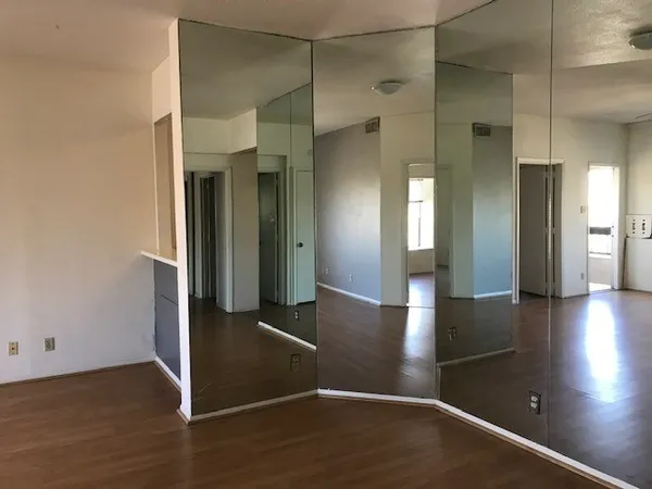 a view of a hallway with wooden floor