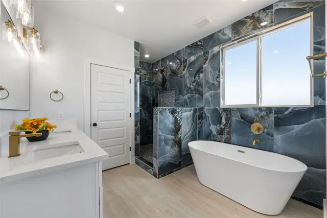 a bathroom with a bathtub and shower